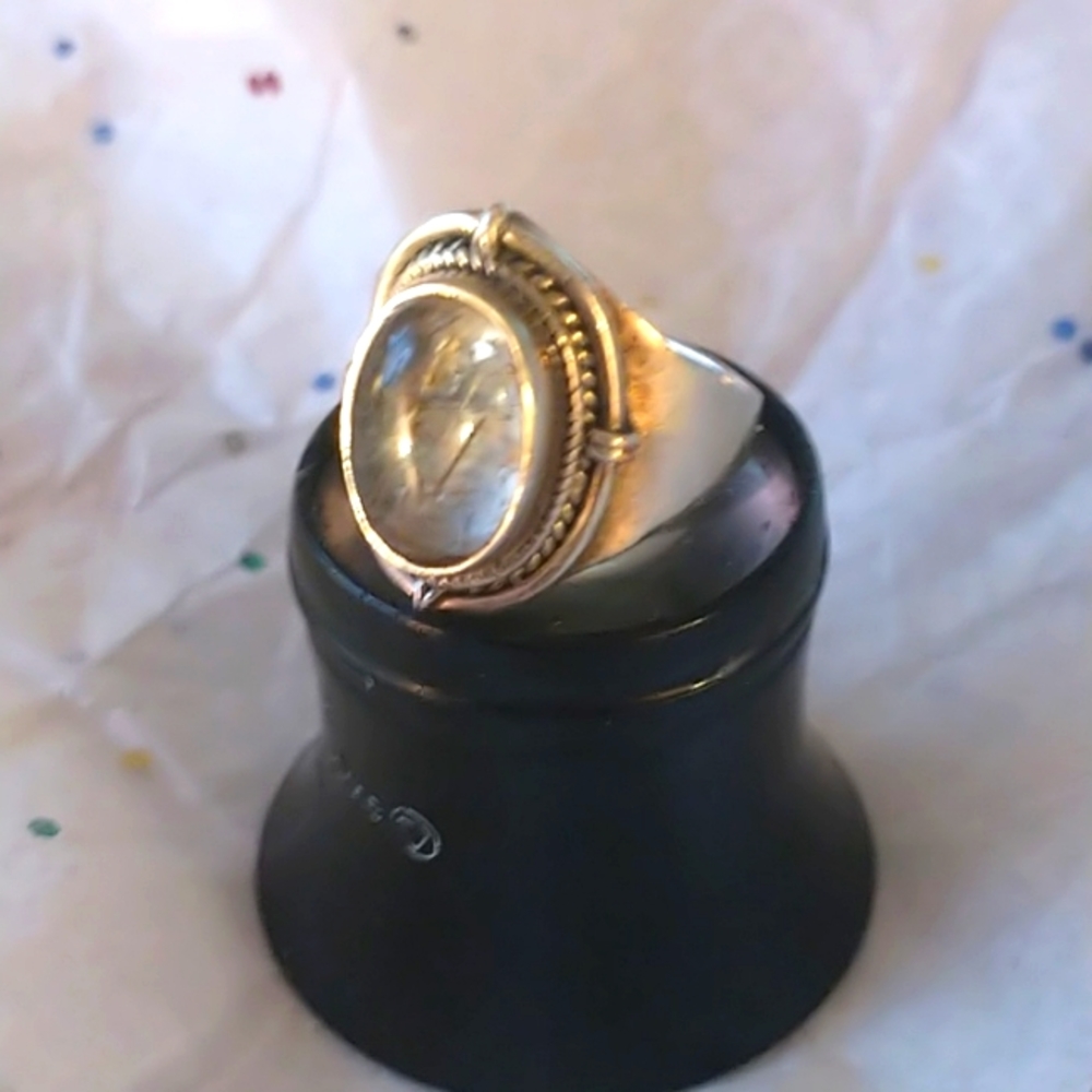 Silver stone has fossil inside, size 7.